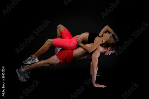 Feeling support. Sportsman push ups workout with fit girl on back. Couple loving sport. Sporty family. Couple workout. Exercises for muscles. Personal instructor in gym. Clothes for workout training