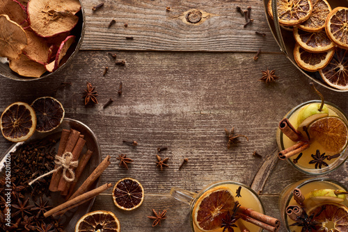 top view of traditional pear mulled wine with spices on wooden rustic table with copy space