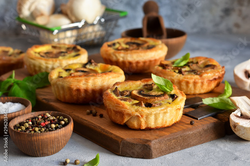 Puff pastry cake with mushrooms on a concrete background.