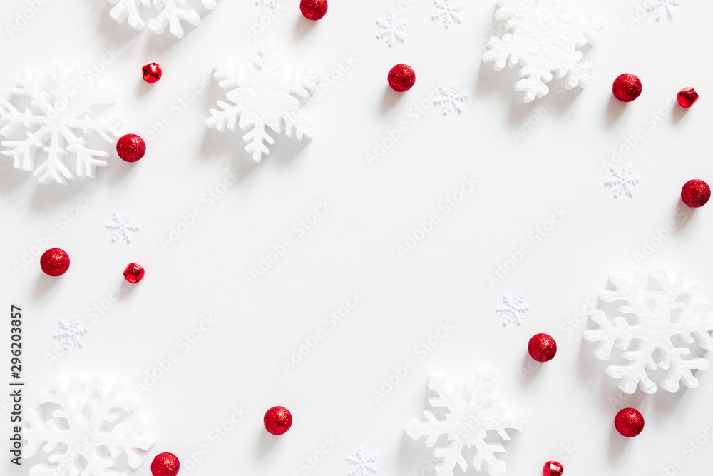 Christmas holiday composition. White snowflakes, Xmas red decorations on white background. Christmas, New Year, winter concept. Flat lay, top view, copy space Christmas holiday composition. White snowflakes, Xmas red decorations on white background. Christmas, New Year, winter concept. Flat lay, top view, copy space