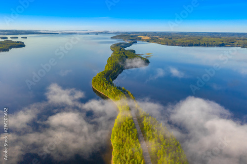 Aerial view of Pulkkilanharju Ridge, Paijanne National Park, southern part of Lake Paijanne. Landscape with drone. Fog, Blue lakes, fields and green forests from above on a sunny summer morning. photo