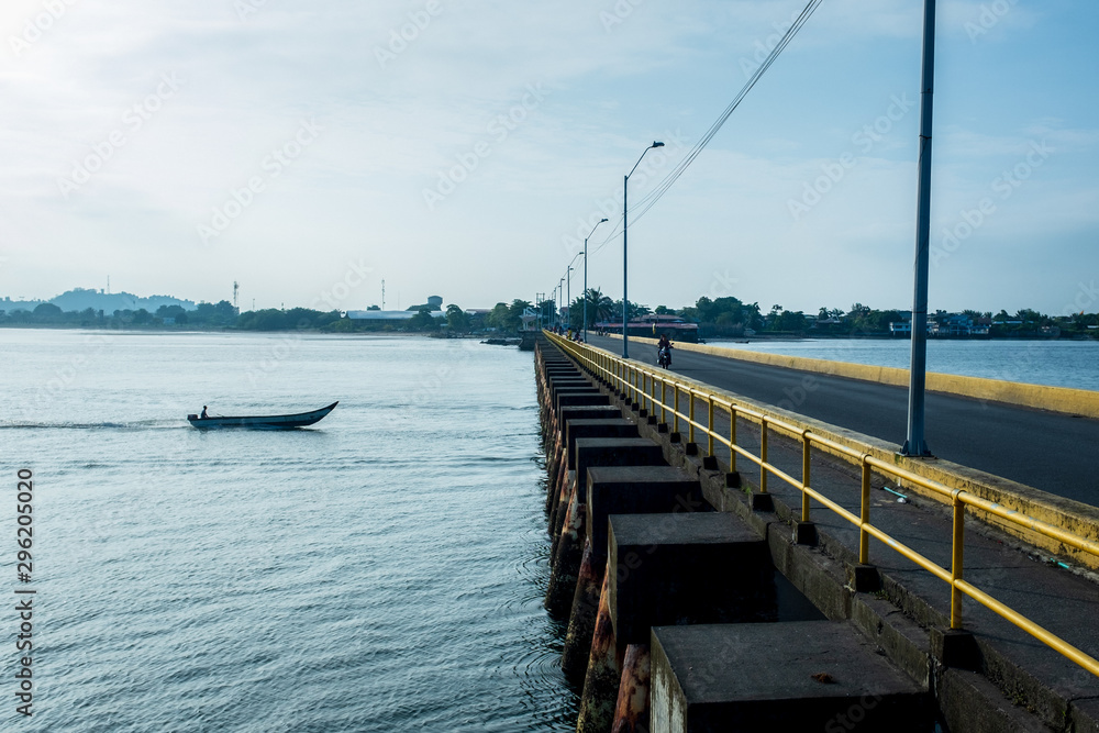 Man on Speed Boat Crossing A Bridge in The Port of Tumaco, Colombia