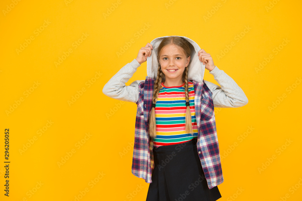 Hairdresser salon. Little girl. Small child with cute braids hairstyle on yellow background. Child care concept. Preteen girl colorful clothes. Childrens shop store mall. Adorable girl beautiful face Hairdresser salon. Little girl. Small child with cute braids hairstyle on yellow background. Child care concept. Preteen girl colorful clothes. Childrens shop store mall. Adorable girl beautiful face
