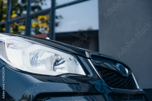 Headlamp and radiator grille of black modern car