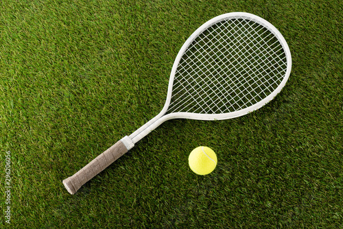 top view of tennis racket and ball on green grass, sports betting concept © LIGHTFIELD STUDIOS