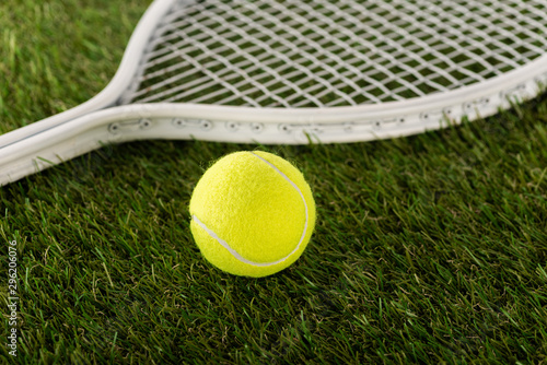tennis racket and ball on green grass, sports betting concept