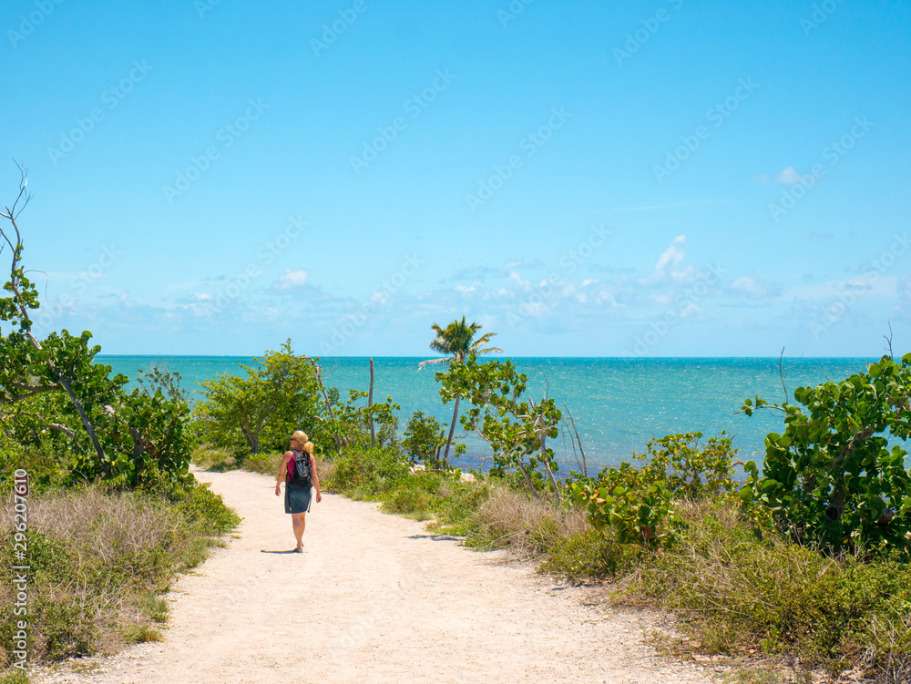 A girl is walking alone at Bahia Honda State Park. Bahia Honda is an island in the lower Florida Keys, USA. Travel and vacation concept.