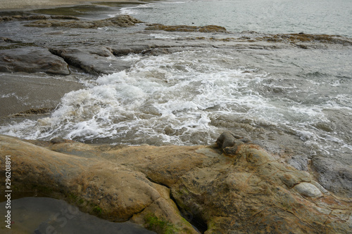 stones in water. waves of the ocean or sea beat against the rocks