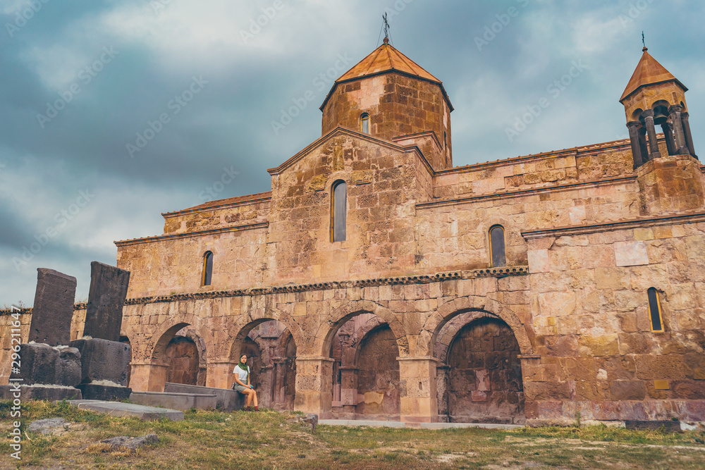 tourist girl woman visiting Odzun Church, 5th–7th century, Armenian Apostolic Church. Odzun, Lori Province, Armenia