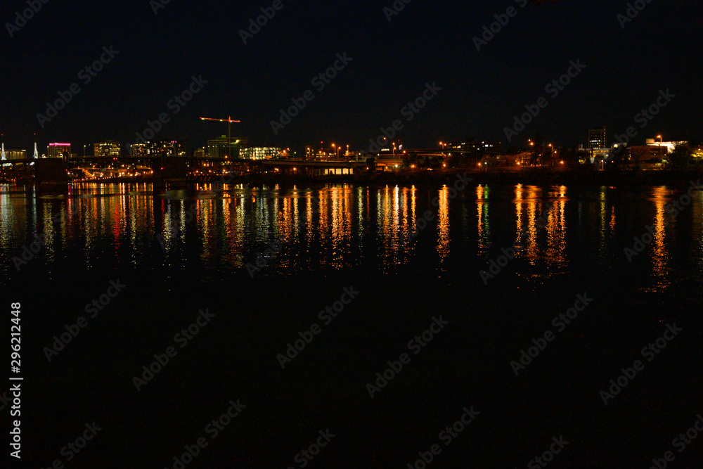 City at night, landscape. Beautiful night city with lights and reflection in the river.