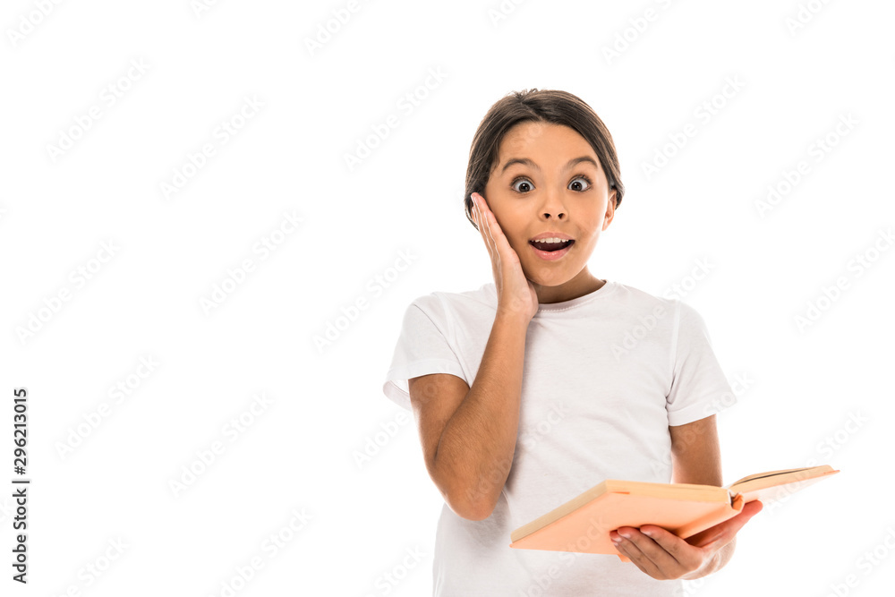 surprised kid touching face while holding book isolated on white surprised kid touching face while holding book isolated on white
