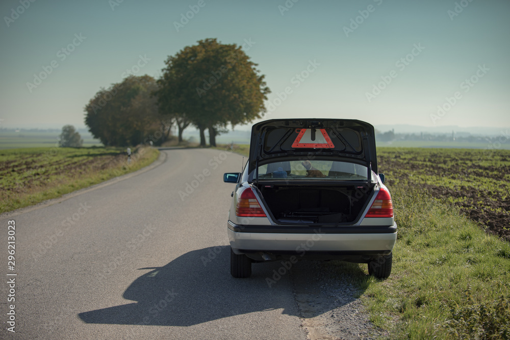 Old car with breakdown on country road Old car with breakdown on country road