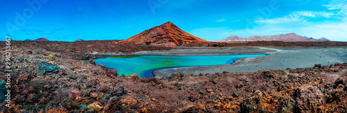 Impressive and scenic volcanic nature unique in Timanfaya National Park.Red mountain and green puddle near the sea coast in Canary island,Lanzarote.Spain beachs photo