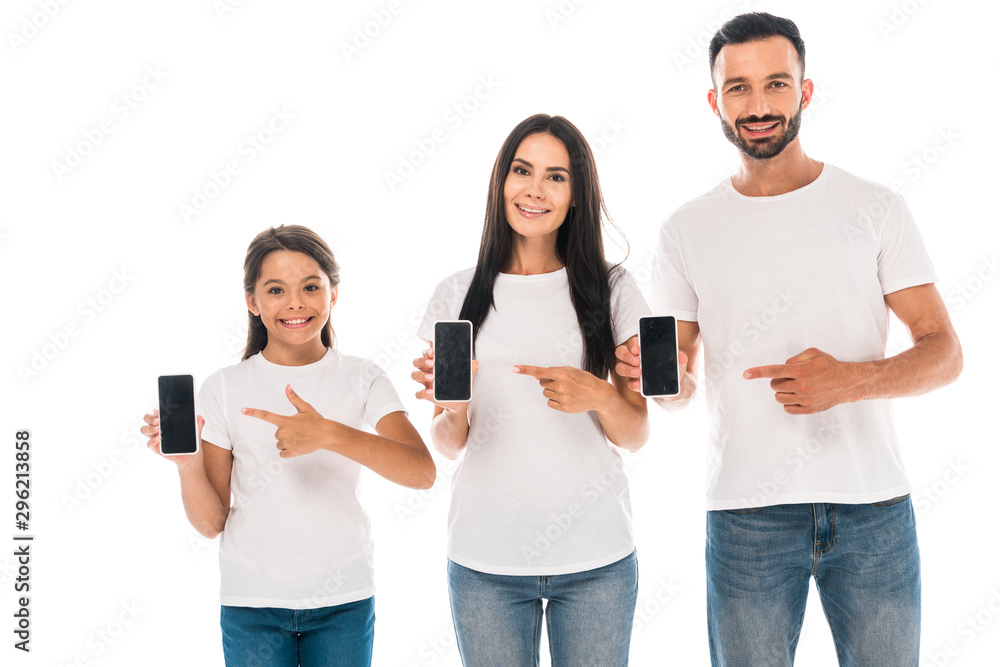 happy parents and kid pointing with fingers at smartphones with blank screens isolated on white happy parents and kid pointing with fingers at smartphones with blank screens isolated on white