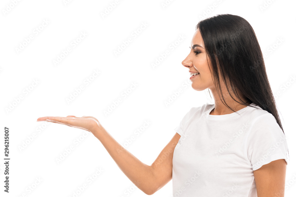 side view of happy woman pointing with hand isolated on white side view of happy woman pointing with hand isolated on white
