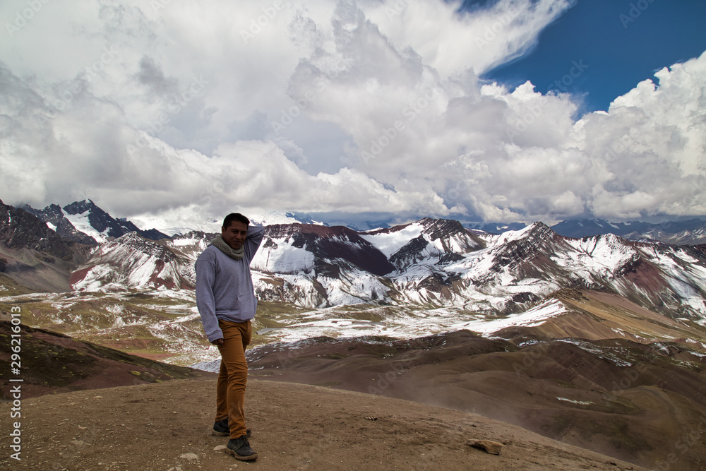 Man with panoramic view. Hiking scene in Vinicunca, Cusco region, Peru. Montana of Seven Colors, Rainbow Mountain