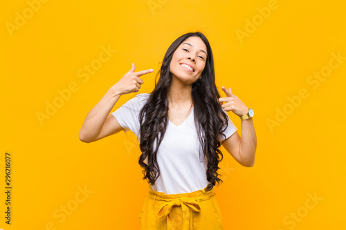 Tableau sur toile young pretty latin woman smiling confidently pointing to own broad smile, positi