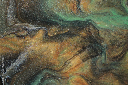 This abstract acrylic background in earth tones blends and flows resembling an ancient cave painting in colors of burnt sienna, moss green, black, shimmering gold, and glittery silver.