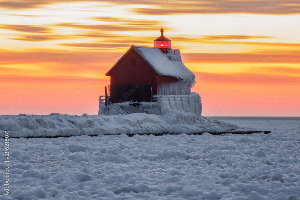 frozen lighthouse at sunset