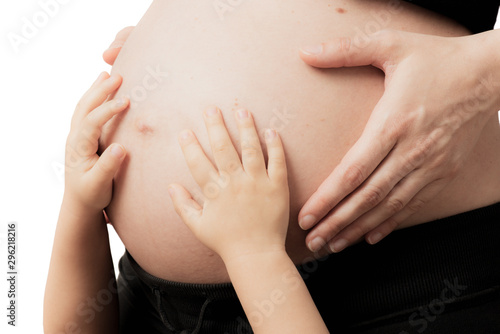 hands of child on pregnant woman