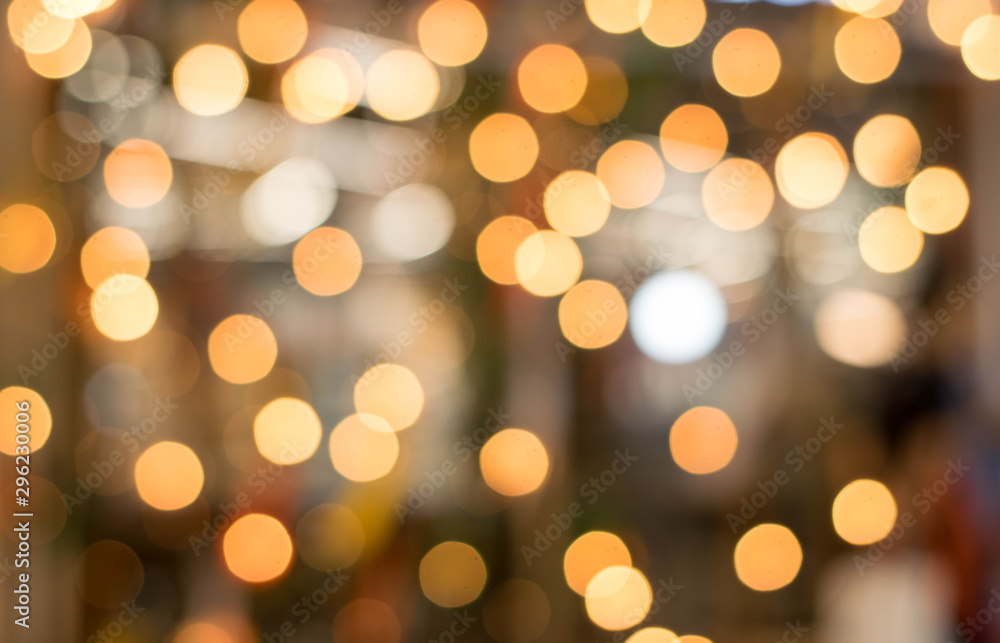 Fototapeta premium Blurred bokeh lights in orange circles to gold.