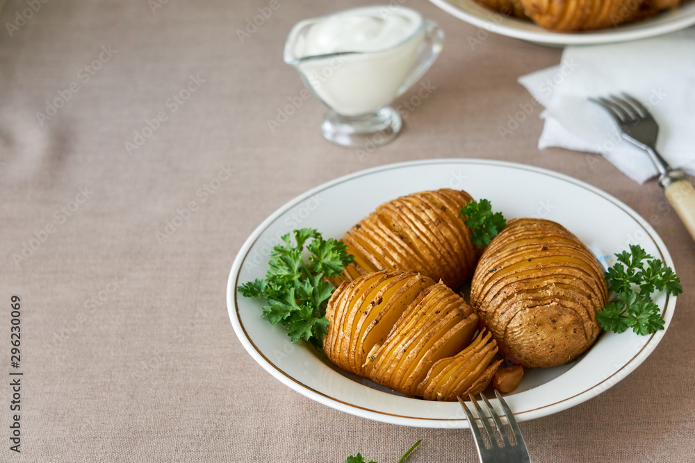 Baked potatoes with parsley on a white plate