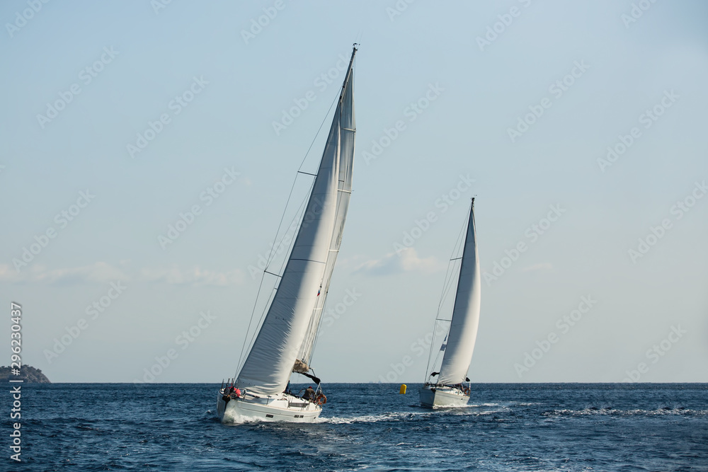 Sailing ship yachts with white sails in the Aegean sea during sail regatta..
