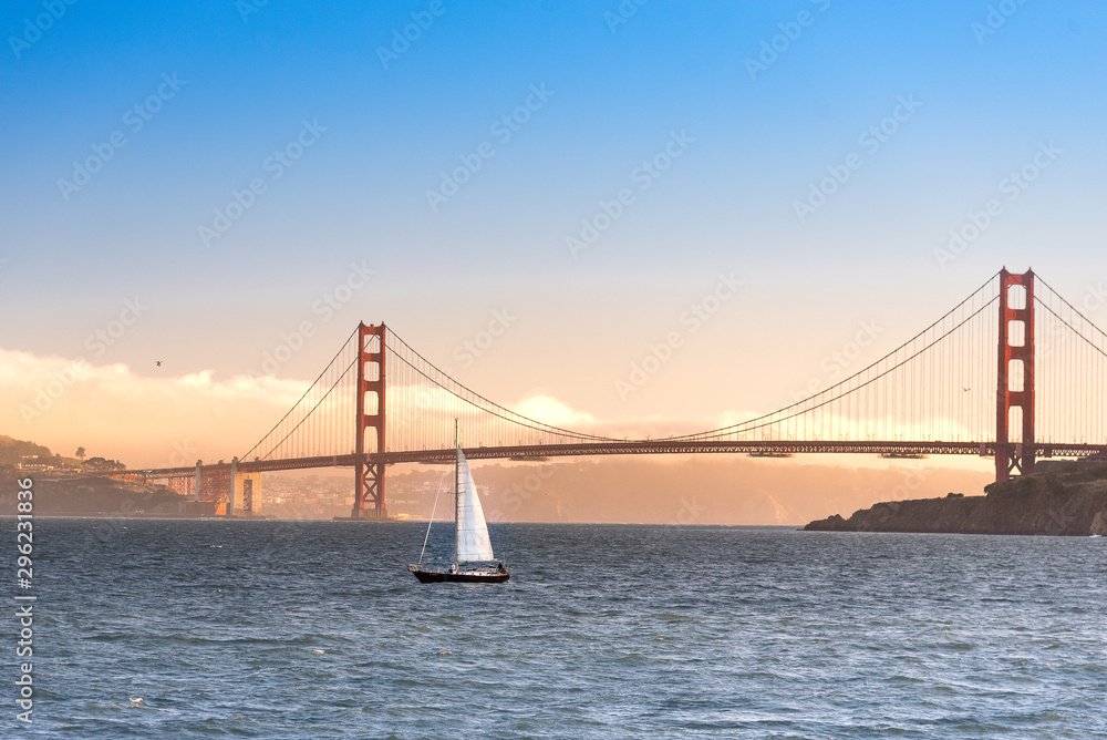 Golden gate bridge sunset with sailboat