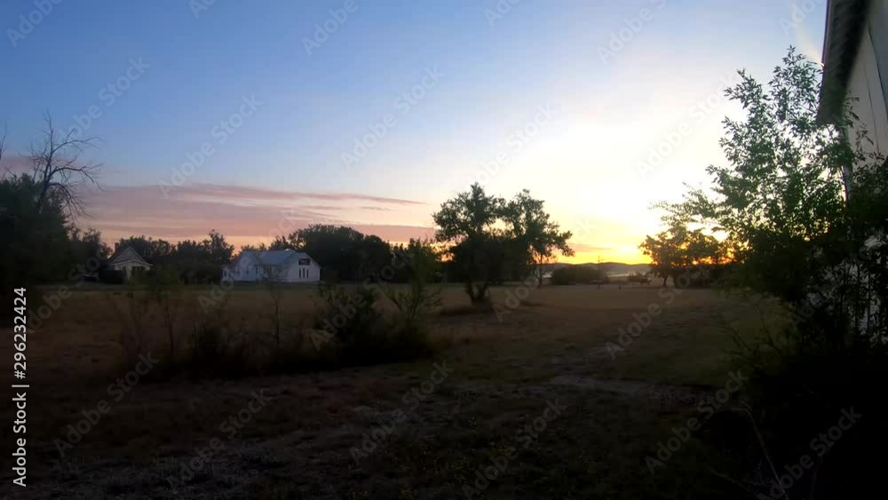 A abandoned white building in a small town and a field with a small church in the distance. A abandoned white building in a small town and a field with a small church in the distance.