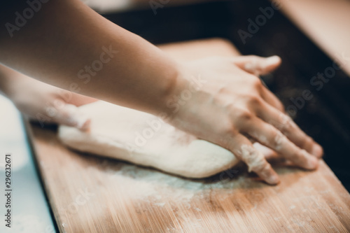 Woman prepare dumpling skin, Making dough on wooden table