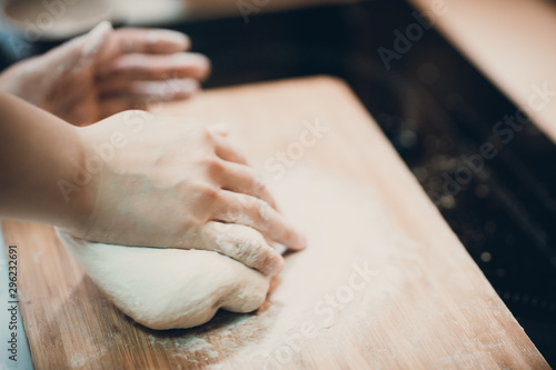 Woman prepare dumpling skin, Making dough on wooden table