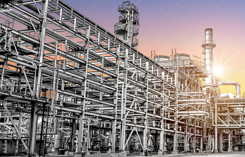 Oil and gas refinery plant form industry petroleum zone,Refinery equipment pipeline steel at sunrise. -image