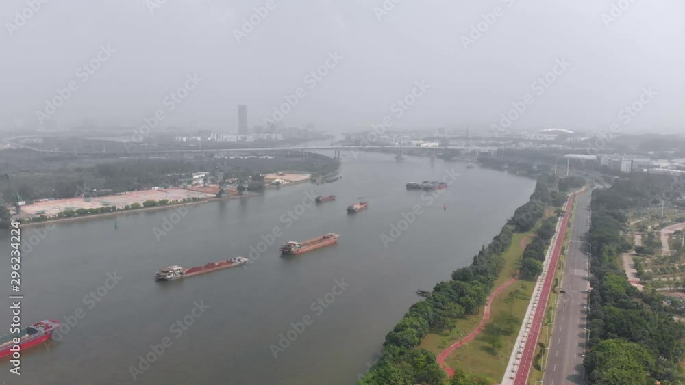A large number of cargo ships are anchored near a small cargo port. Guangzhou, China A large number of cargo ships are anchored near a small cargo port. Guangzhou, China