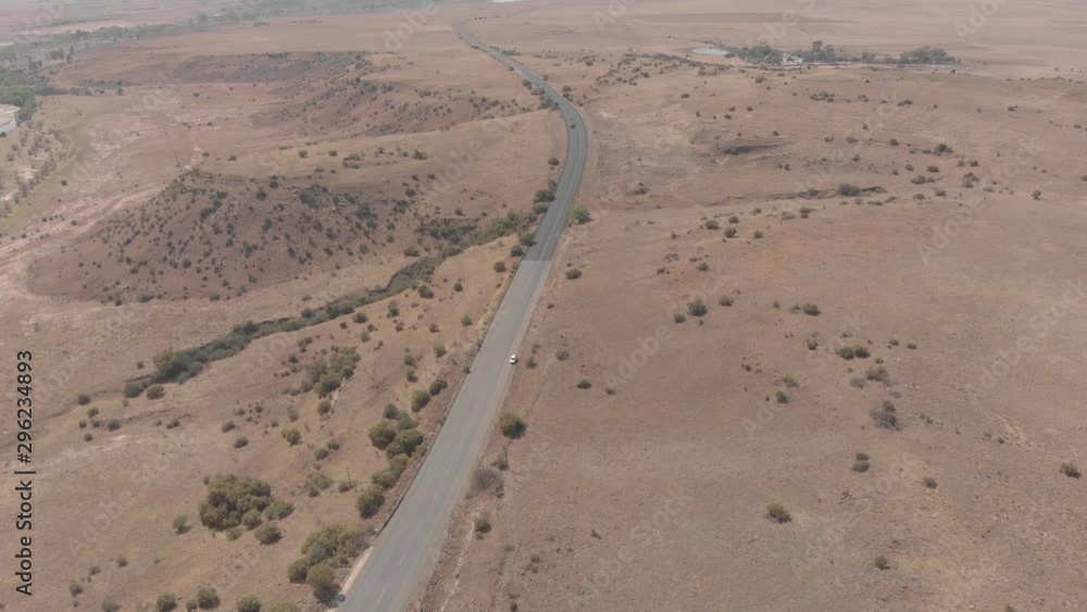 aerial shot descending to a stand still vehicle on a busy road aerial shot descending to a stand still vehicle on a busy road