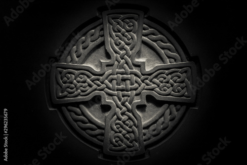 Wonderful embossed Celtic stone cross, full of details and textures in its elaborate carvings.