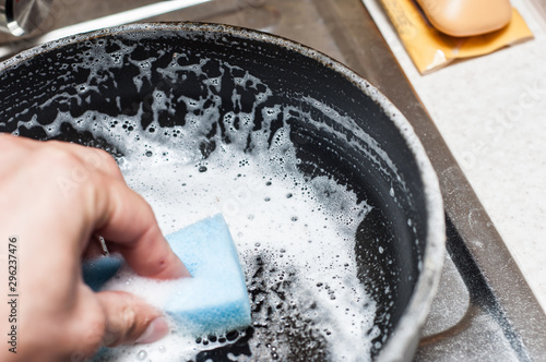 Hand wash the pan with a sponge and foamy detergent against grease.