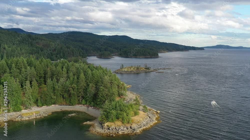 Aerial view over inlet, ocean and island with boat and mountains in beautiful British Columbia. Canada. 4K. Aerial view over inlet, ocean and island with boat and mountains in beautiful British Columbia. Canada. 4K.