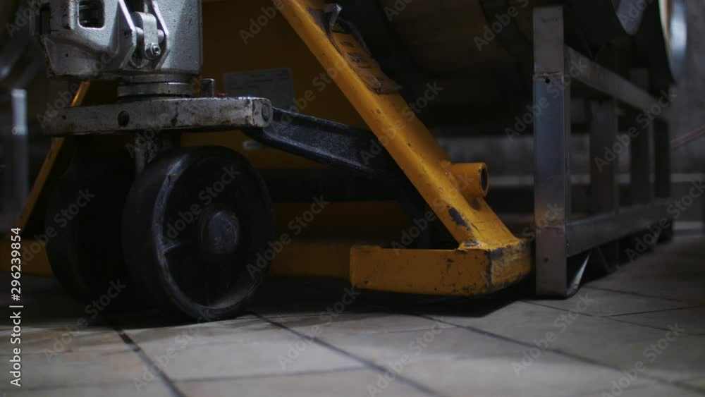 A hand cart, carrying casks of wine barrels, is lowered in stunning 4K resolution. A hand cart, carrying casks of wine barrels, is lowered in stunning 4K resolution.