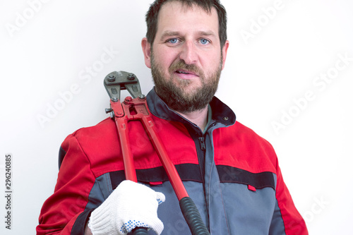 grinning worker in a suit on his shoulder who has a large pair of metal scissors