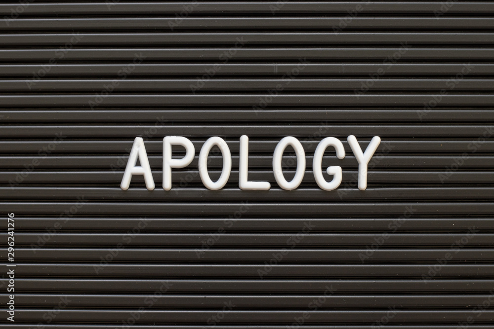 Black color felt letter board with white alphabet in word apology background Black color felt letter board with white alphabet in word apology background