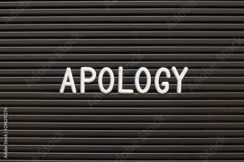 Black color felt letter board with white alphabet in word apology background