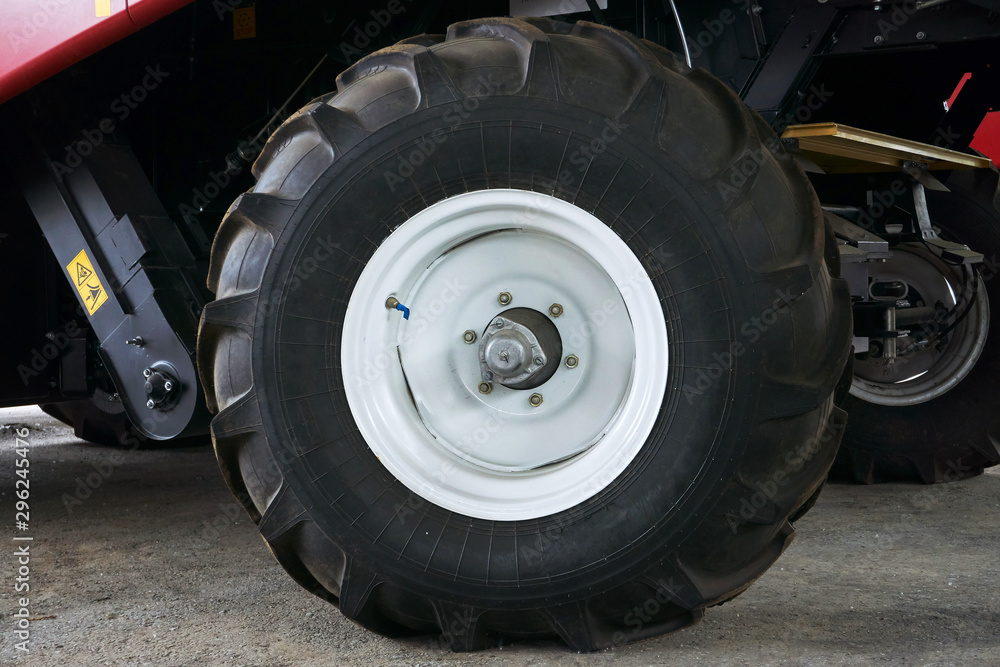 large tires with a large tread on a new agricultural tractor after assembly at the plant on a sunny day