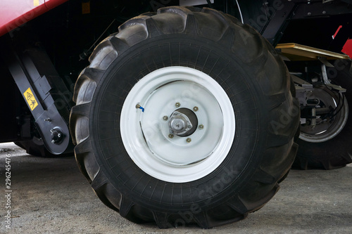 large tires with a large tread on a new agricultural tractor after assembly at the plant on a sunny day