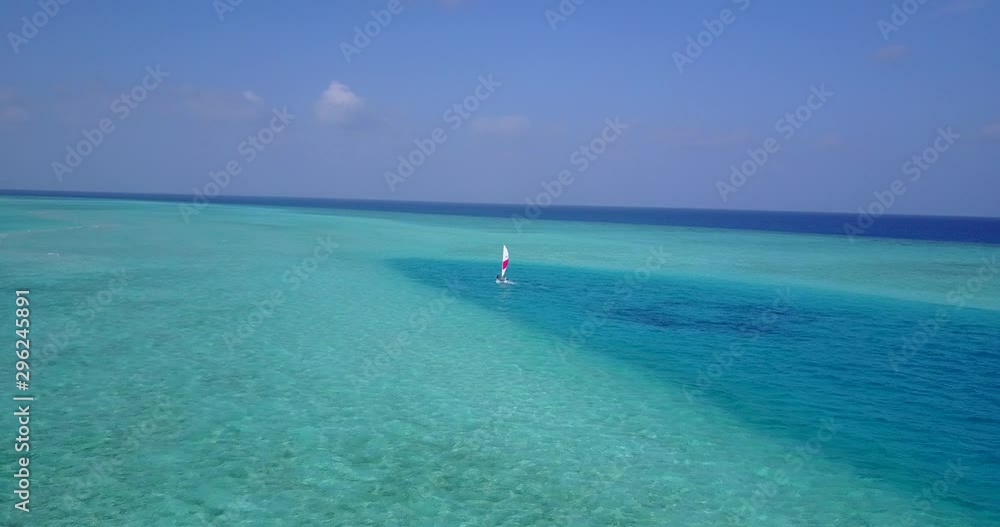 Small sailing dinghy aerial orbit shot. Turquoise water. Holiday activity. Small sailing dinghy aerial orbit shot. Turquoise water. Holiday activity.