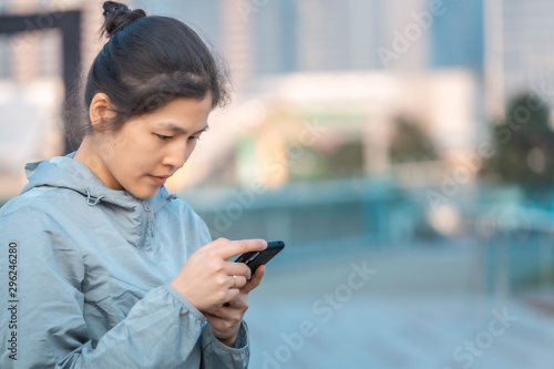 Woman playing mobile game outdoor