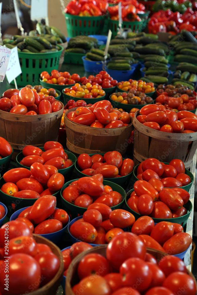 Biologic, natural cultivated tomatoes on a market counter.