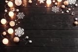 Christmas decorations with lights on dark wooden background