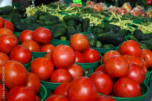 Biologic, natural cultivated tomatoes on a market counter.