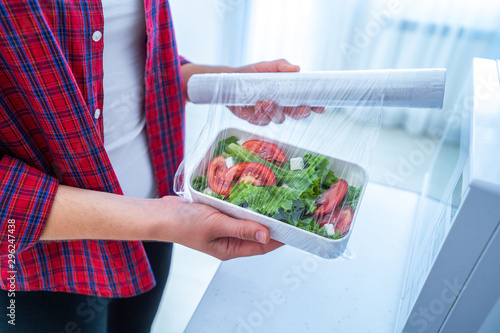 Using food polyethylene plastic film for food storage in fridge at home