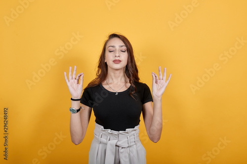 Relaxed girl doing some sort of yoga to attain peace of mind. The lighter the mind the better the thought process and more work potential. photo